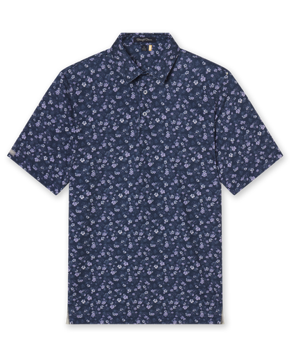Men's Dogwood Polo in New Indigo, flat lay front view featuring a navy short sleeve polo with an all-over scattered floral blossom print in lavender and white