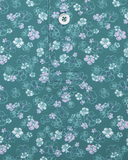 Men's Dogwood Polo in Sage, close-up detail view featuring scattered white and lavender floral print and Straight Down logo engraved button with placket detail
