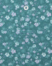 Men's Dogwood Polo in Sage, close-up detail view featuring scattered white and lavender floral print and Straight Down logo engraved button with placket detail
