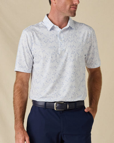 Model wearing the South Beach Polo in Blue Shade, featuring a subtle light blue coastal-inspired print on white.