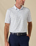 Model wearing the South Beach Polo in Blue Shade, featuring a subtle light blue coastal-inspired print on white.