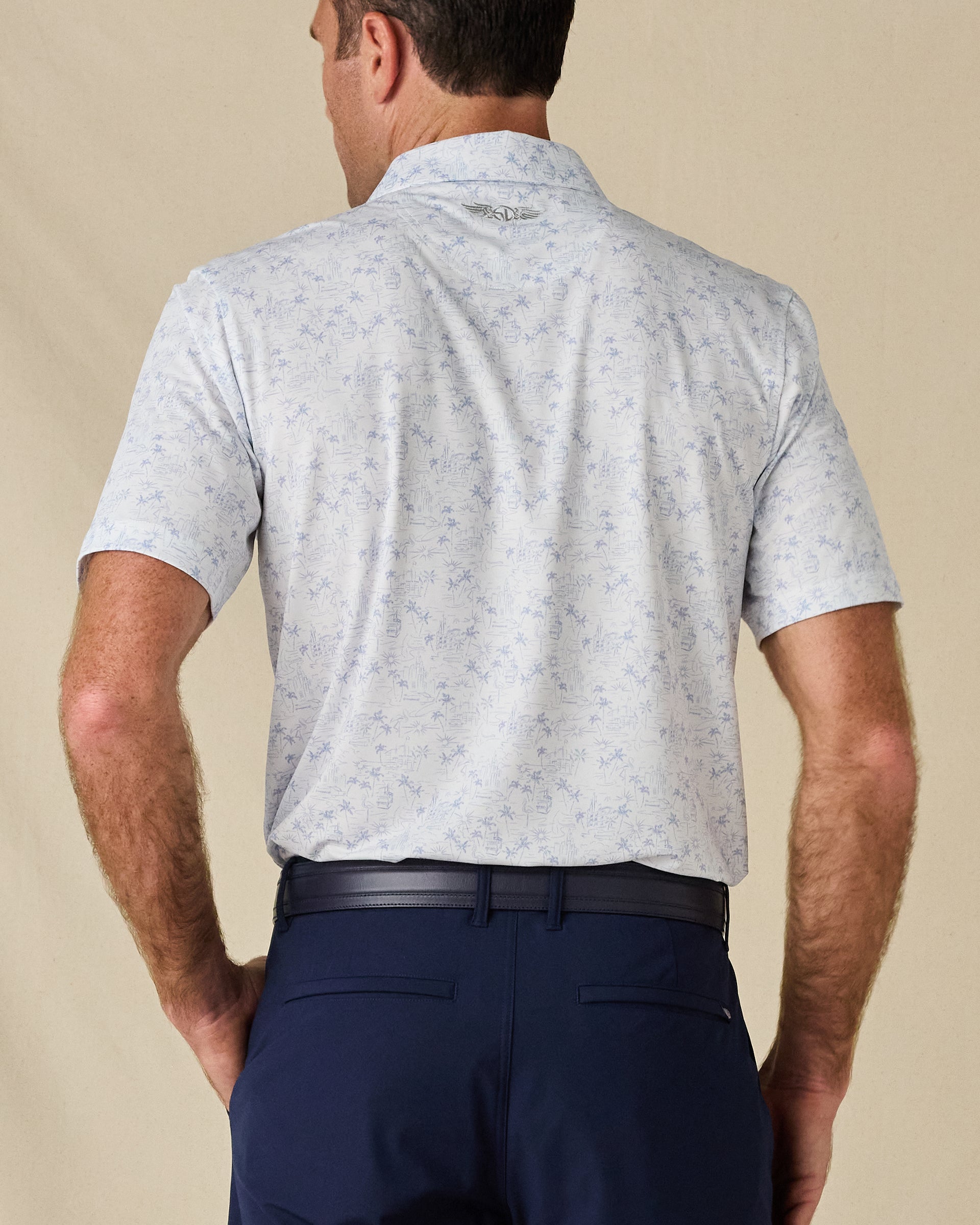 Back view of the South Beach Polo in Blue Shade, highlighting the all-over print and embroidered logo below the collar.