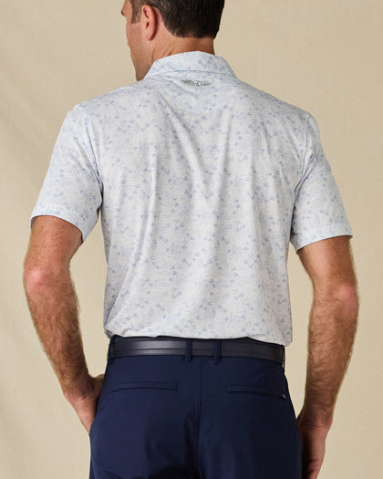 Back view of the South Beach Polo in Blue Shade, highlighting the all-over print and embroidered logo below the collar.