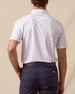 Back view of men’s South Beach Polo in violet with collar logo detail, tucked into navy shorts