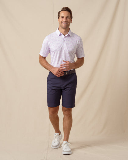 Men’s South Beach Polo in violet styled with navy shorts, brown belt, and white sneakers