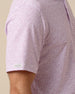 Close-up of men’s haze polo with subtle all-over floral print and short sleeve logo detail