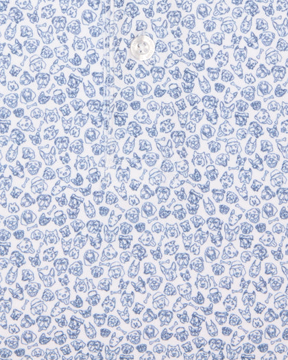 Men's Dog Pound Polo in Moonlight, close-up flat lay view featuring a white fabric with an all-over scattered dog face and bone print in navy with a visible button placket detail