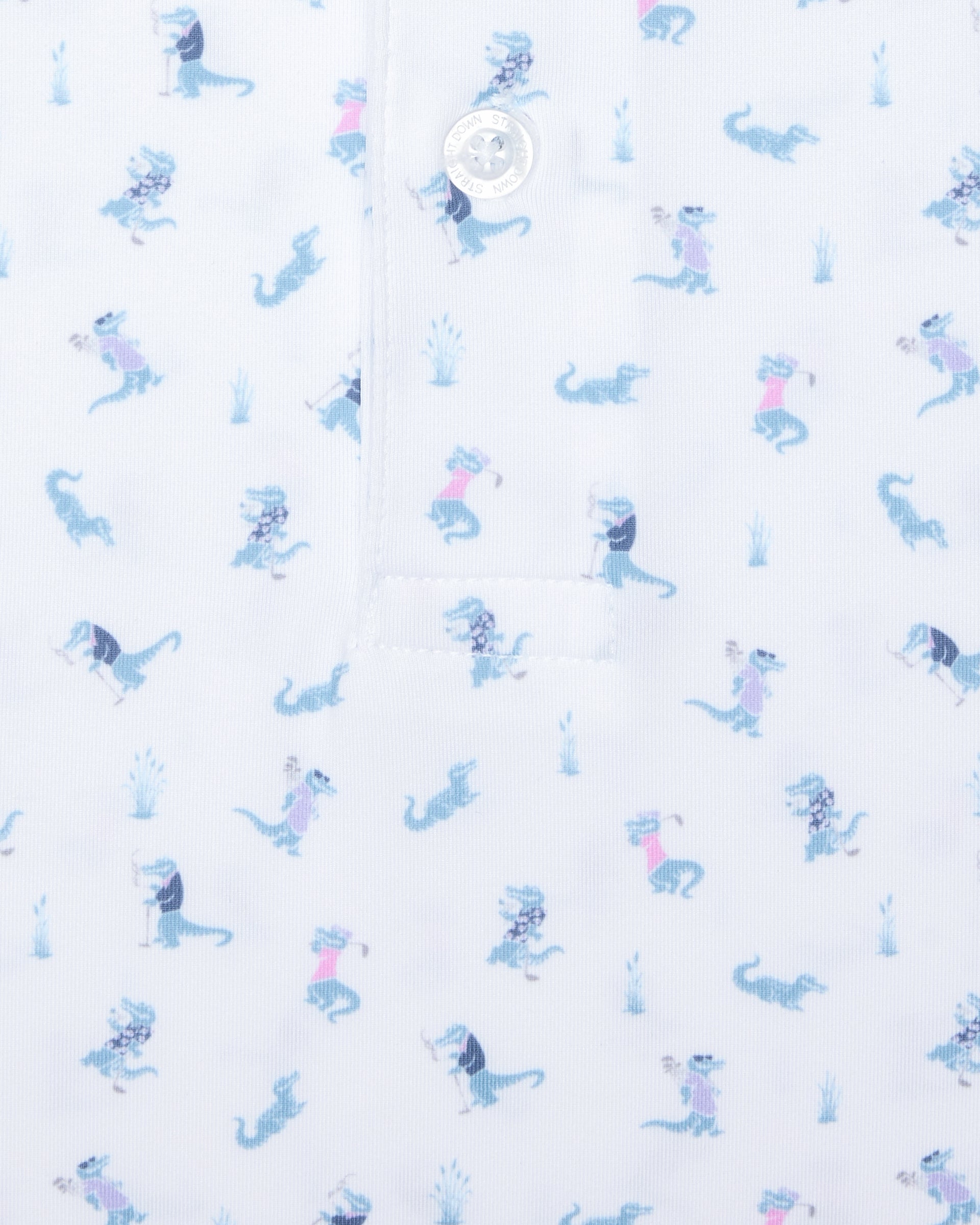 Men's Gators Polo in Violet, close-up flat lay view featuring a white fabric with an all-over scattered golf-playing alligator print in blue and pink with a visible button placket detail