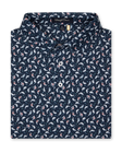 Men's Manatee County Polo in New Indigo, folded flat lay front view featuring a navy short sleeve polo with an all-over scattered golf-playing manatee print in white and pink