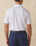 Men's Golden State Polo in Spritz, back view on model featuring a white base with an all-over blue and pink California landscape sketch print, with Straight Down logo embroidered at upper back, paired with navy pants