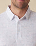 Men's Golden State Polo in Spritz, close-up front view on model highlighting the blue and pink California landscape sketch print on a white base