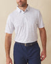 Men's Golden State Polo in Spritz, front view on model featuring a white base with an all-over blue and pink California landscape sketch print, paired with navy pants and a dark leather belt