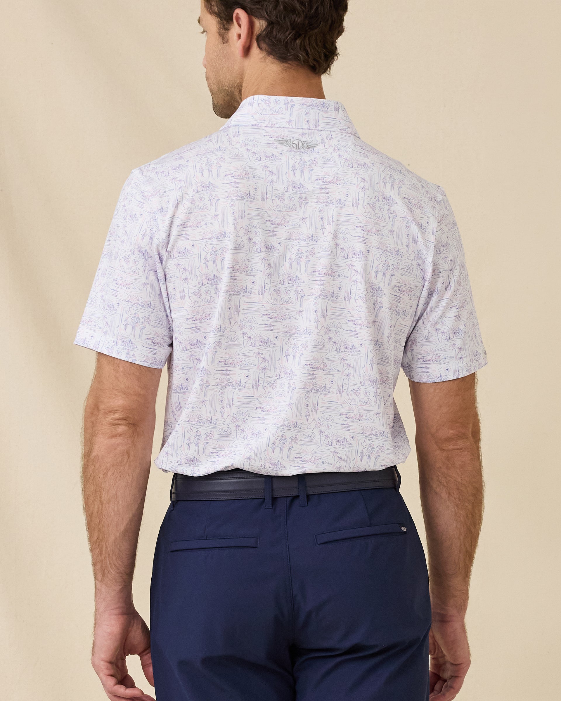 Back view of the Golden State Polo in Tidal displaying the allover California-inspired scenic print and clean silhouette