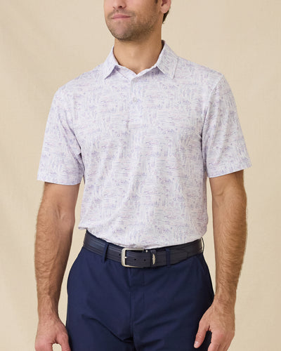 Model wearing the Golden State Polo in Tidal, highlighting the allover California-inspired scenic print and classic performance fit