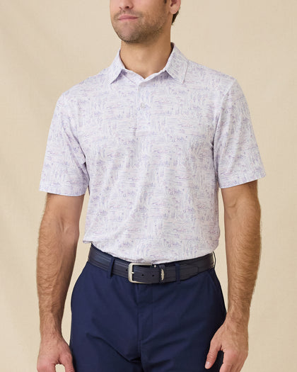 Model wearing the Golden State Polo in Tidal, highlighting the allover California-inspired scenic print and classic performance fit
