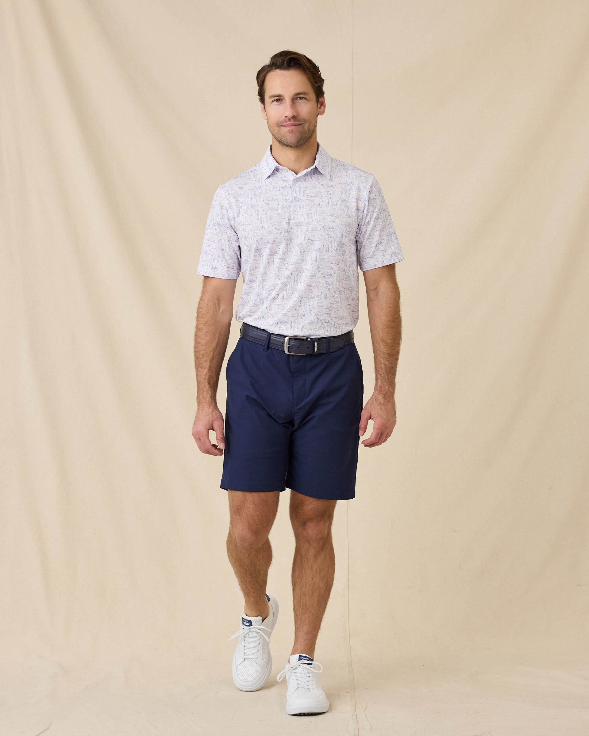 Model styled in the Golden State Polo in Tidal with navy shorts and white sneakers 