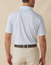 Men's Slam Dunk Polo in Coastal, back view on model featuring an allover basketball hoop and ball print in light blue and pink on white, with the Straight Down logo embroidered at center back, paired with khaki pants and a brown belt