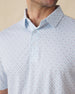 Men's Slam Dunk Polo in Coastal, close-up front chest detail featuring a button placket and an allover basketball hoop and ball print in light blue and pink on white