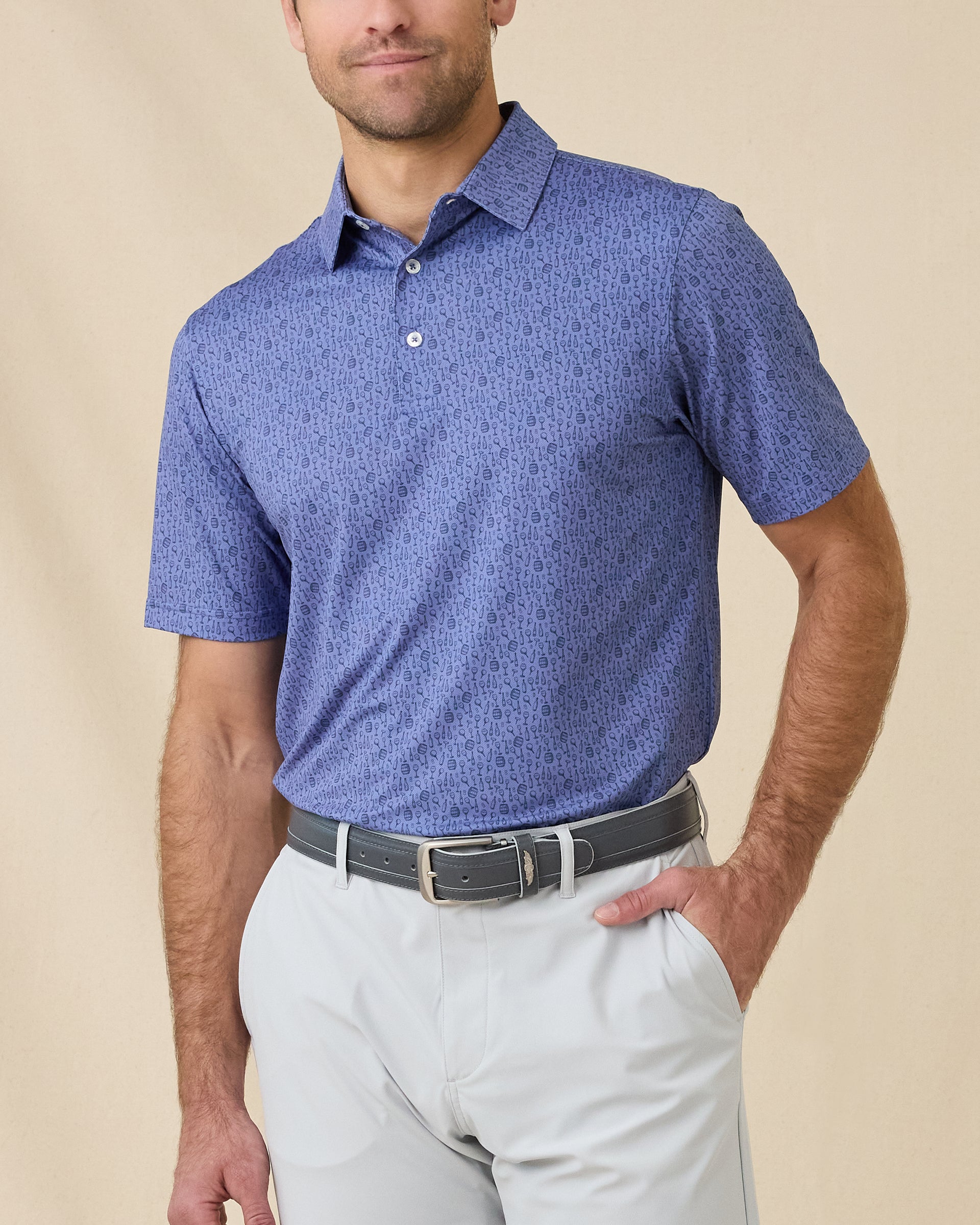 Model wearing the Tannins & Tees Polo in Tidal Blue, highlighting the playful golf and wine-inspired print and classic fit
