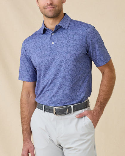 Model wearing the Tannins & Tees Polo in Tidal Blue, highlighting the playful golf and wine-inspired print and classic fit