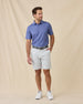 Model styled in the Tannins & Tees Polo in Tidal Blue with light gray shorts and white sneakers for a polished golf-ready look