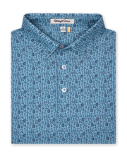 Men's Tannins & Tees Polo in Coastal, folded flat lay front view featuring a blue base with a scattered wine bottle, wine glass, barrel, and corkscrew print in navy