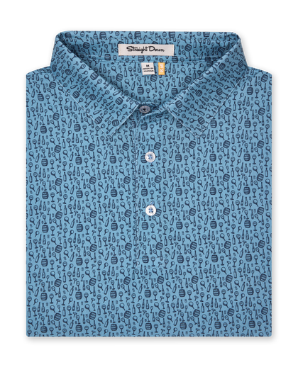 Men's Tannins & Tees Polo in Coastal, folded flat lay front view featuring a blue base with a scattered wine bottle, wine glass, barrel, and corkscrew print in navy