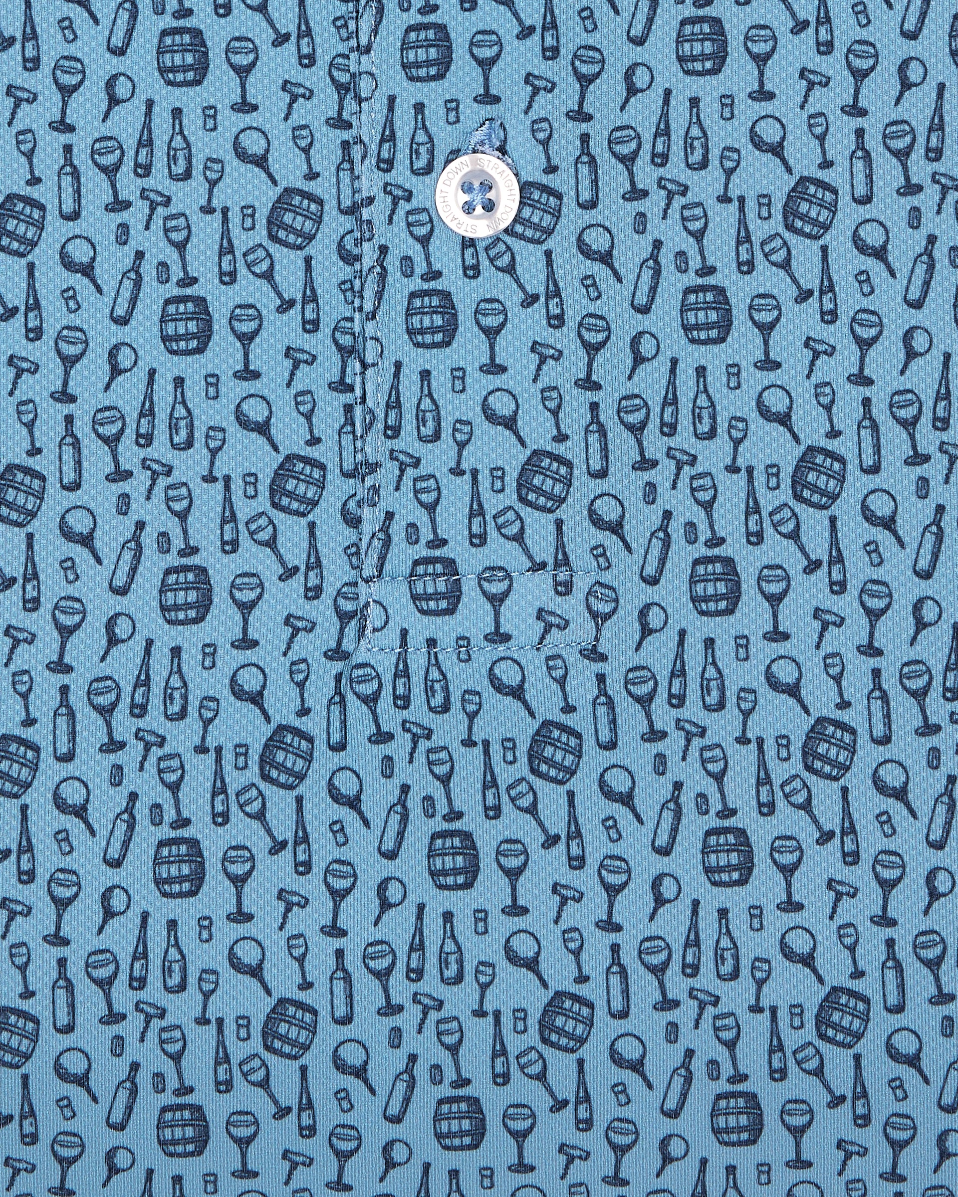 Men's Tannins & Tees Polo in Coastal, close-up flat lay fabric detail view highlighting the scattered wine bottle, wine glass, barrel, and corkscrew print in navy on a blue base