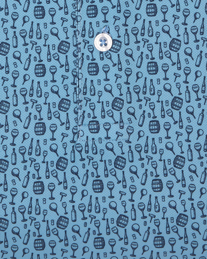 Men's Tannins & Tees Polo in Coastal, close-up flat lay fabric detail view highlighting the scattered wine bottle, wine glass, barrel, and corkscrew print in navy on a blue base
