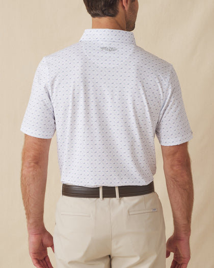 Men's Livingston Polo in White, back view on model featuring a white base with a scattered navy and light blue seagull print, with Straight Down logo embroidered at upper back, paired with khaki pants