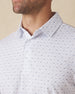 Men's Livingston Polo in White, close-up front view on model highlighting the scattered navy and light blue seagull print on a white base