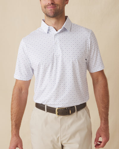 Men's Livingston Polo in White, front view on model featuring a white base with a scattered navy and light blue seagull print, paired with khaki pants and a dark leather belt
