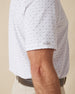 Men's Livingston Polo in White, side detail view featuring a white short sleeve polo with a flying seagull print pattern in navy and light blue tones, with a Straight Down logo tab on the sleeve hem