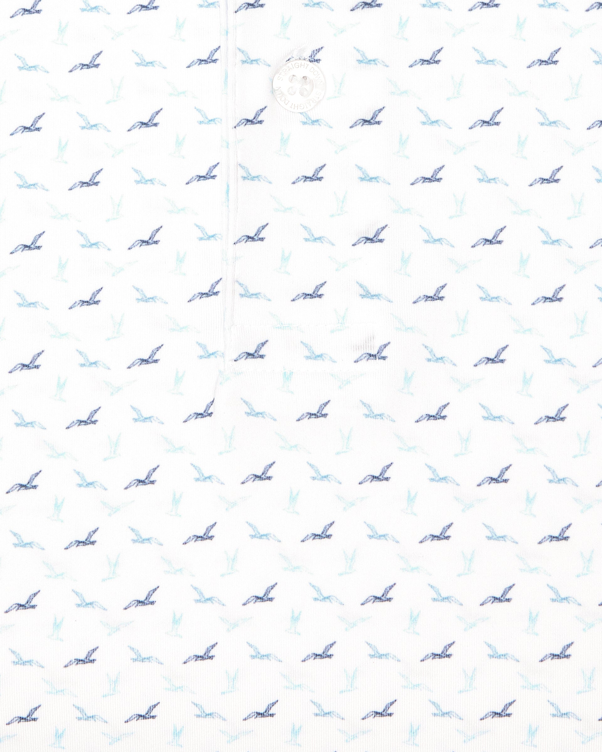Men's Livingston Polo in White, close-up fabric detail view featuring an allover flying seagull print in navy, light blue, and mint tones on a white performance fabric
