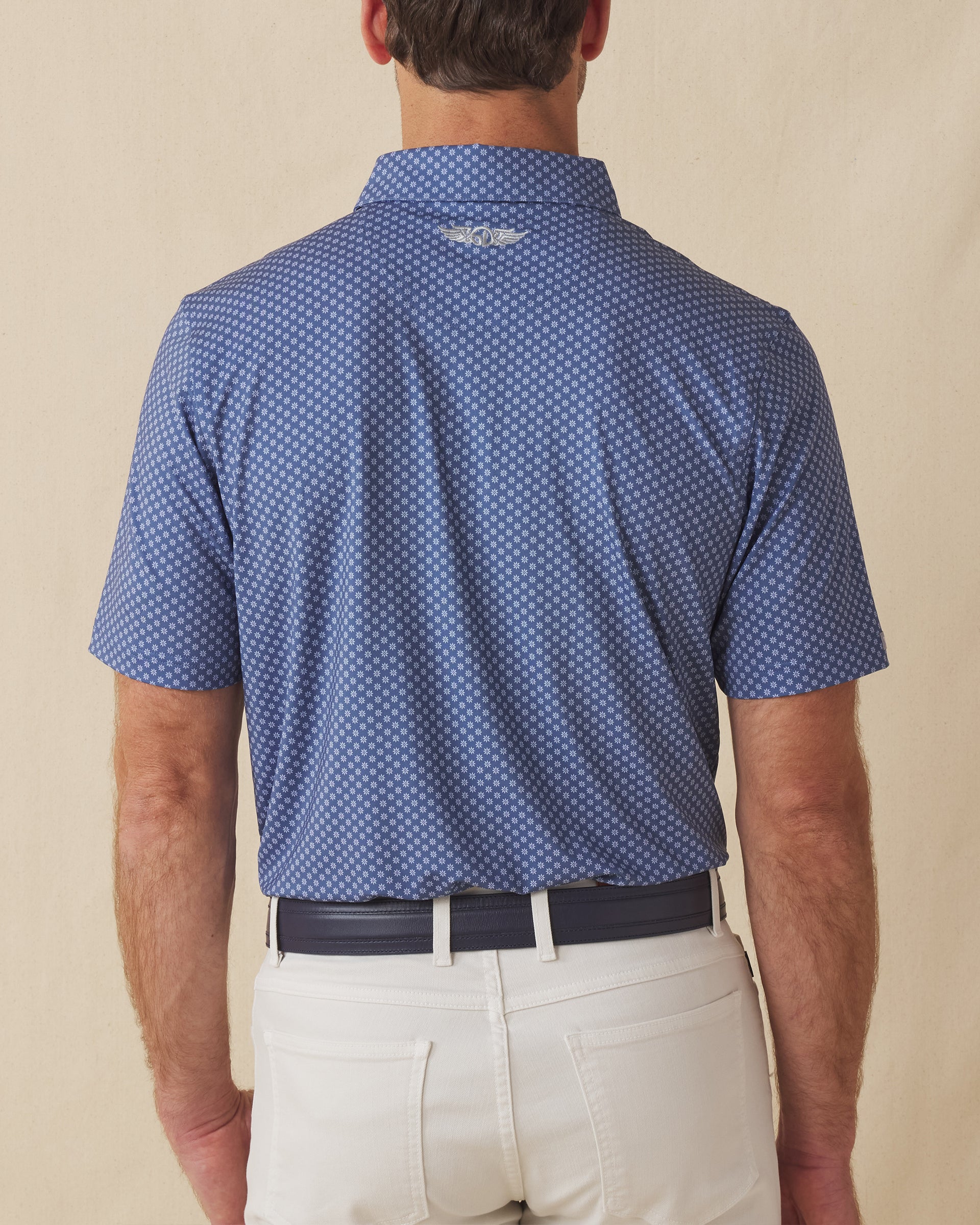 Back view of men’s blue Florian Polo with allover geometric floral print and relaxed fit