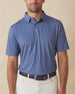 Men’s blue Florian Polo with small geometric floral print, short sleeve, worn tucked into light pants