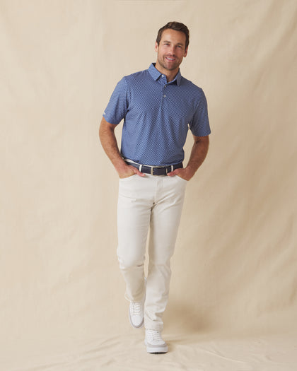 Men wearing blue Florian Polo with light pants and belt, styled for a clean, modern look