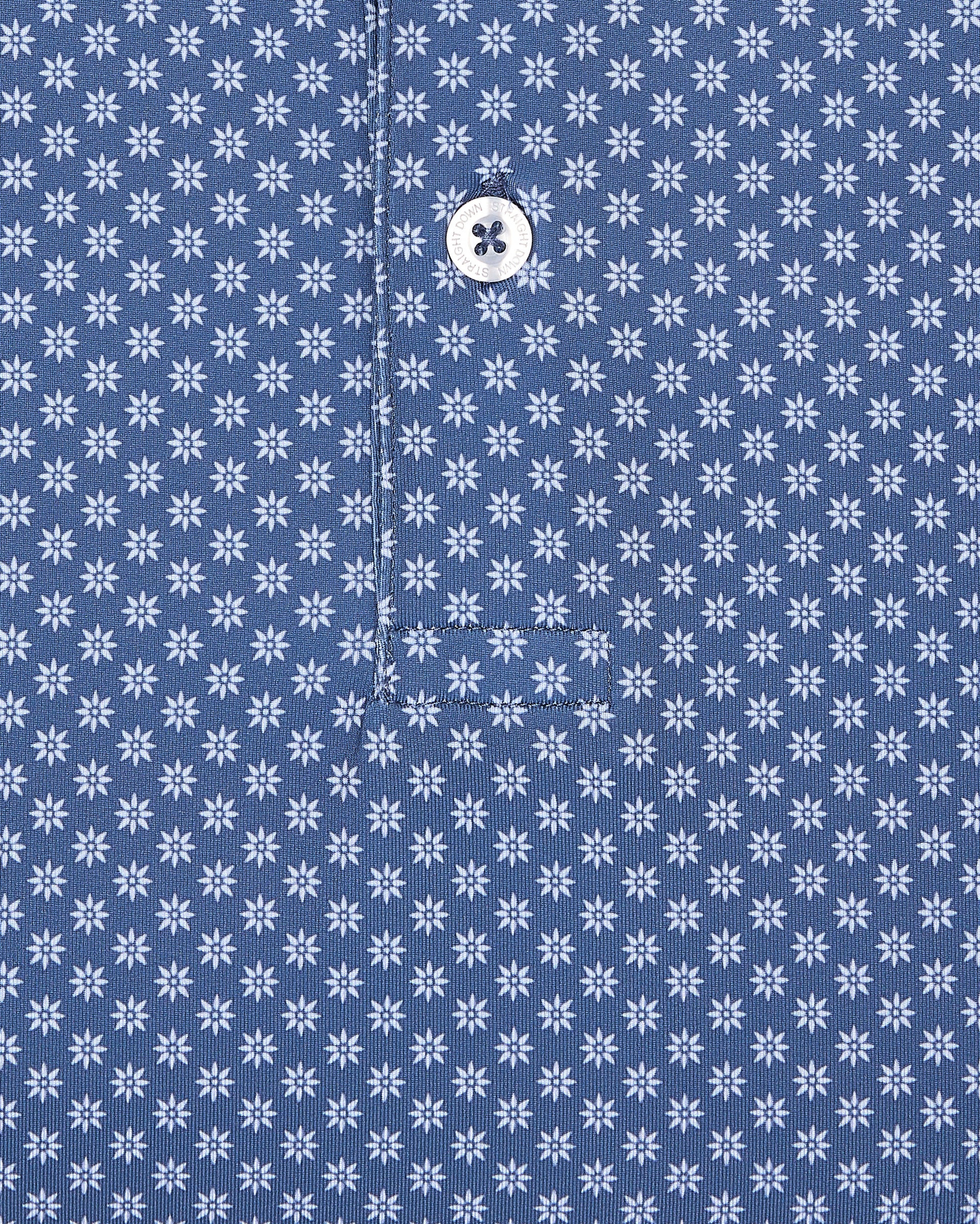 Close-up of blue fabric with small geometric floral print detail