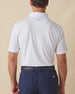 Men's Turtle Island Polo in Coastal, back model view featuring a white short sleeve polo with an allover sea turtle and coral print in light blue and pink tones, with a Straight Down logo at the back collar