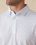 Men's Turtle Island Polo in Coastal, collar detail view featuring an allover sea turtle and coral print in light blue and pink tones on a white performance fabric