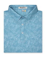 Men's Ka'anapali Polo in Coastal, folded flat lay front view featuring a medium blue short sleeve polo with an allover white tropical floral and palm leaf line-art print