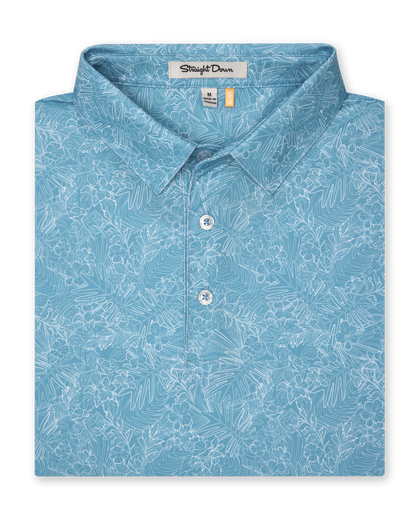 Men's Ka'anapali Polo in Coastal, folded flat lay front view featuring a medium blue short sleeve polo with an allover white tropical floral and palm leaf line-art print