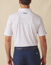 Men's Pimento Cheese Polo in White, back view on model featuring a white base with a scattered golf, sandwich, and drink print in purple, teal, and orange, with Straight Down logo embroidered at upper back