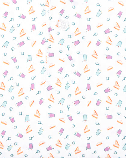 Men's Pimento Cheese Polo in White, close-up flat lay fabric detail view highlighting a scattered golf, sandwich, and drink print in purple, teal, and orange on a white base