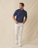Men’s navy martini print polo shirt styled with light pants and white sneakers
