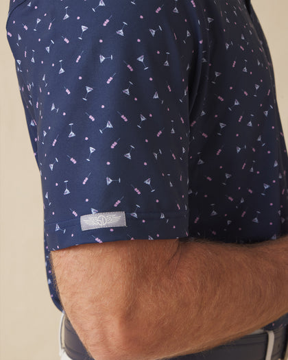 Close-up of navy martini print polo sleeve with logo detail