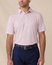 Front view of a male model wearing the Channel Stripe Polo in Seashell tucked into navy pants with a matching navy belt.