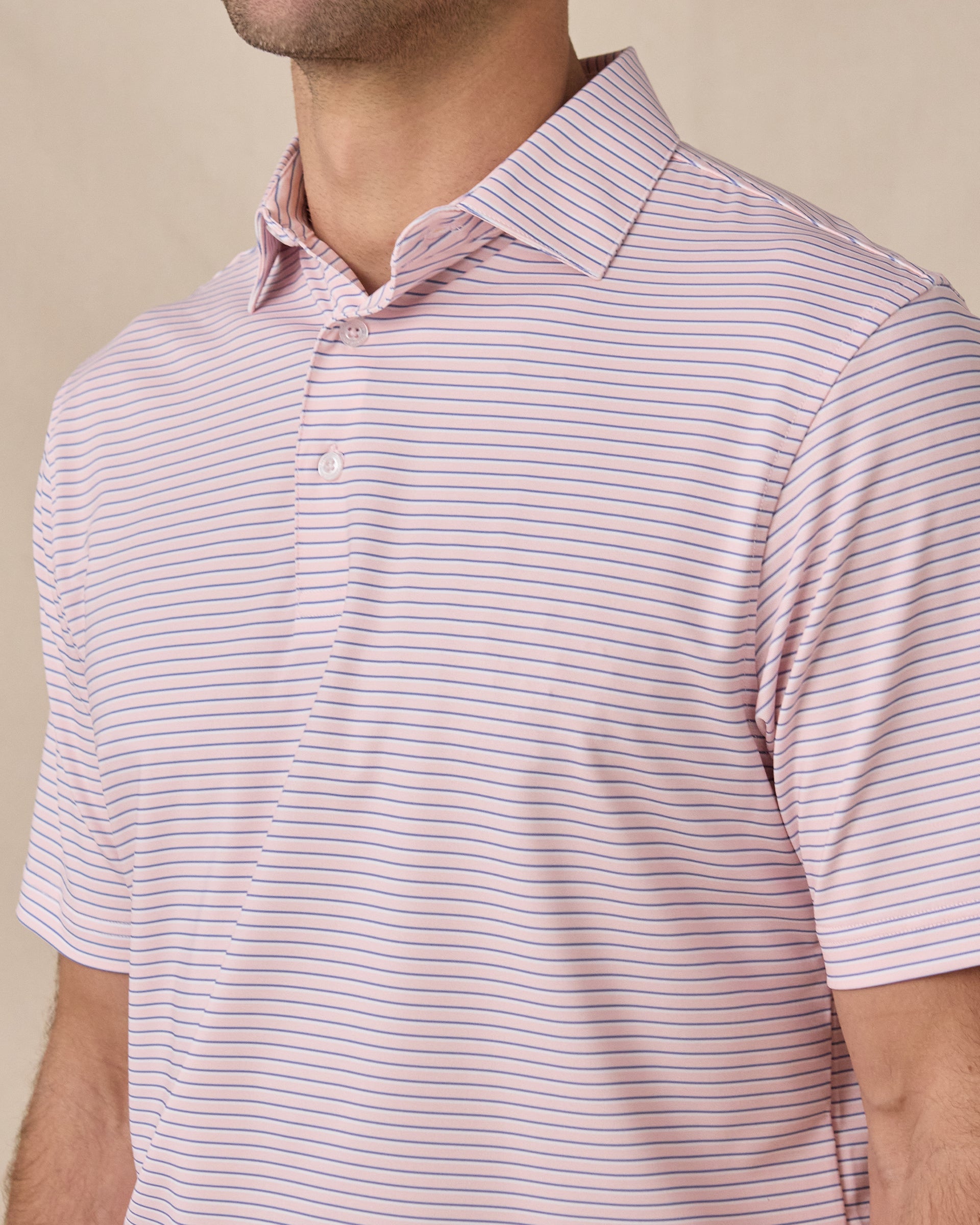 Close-up front view of the Channel Stripe Polo in Seashell, highlighting the fine blue stripes, collar, and button placket.