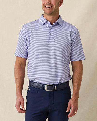 Men's Channel Stripe Polo in Violet, front model view featuring a lavender short sleeve polo with horizontal navy and white pencil stripes paired with navy pants and a navy belt

