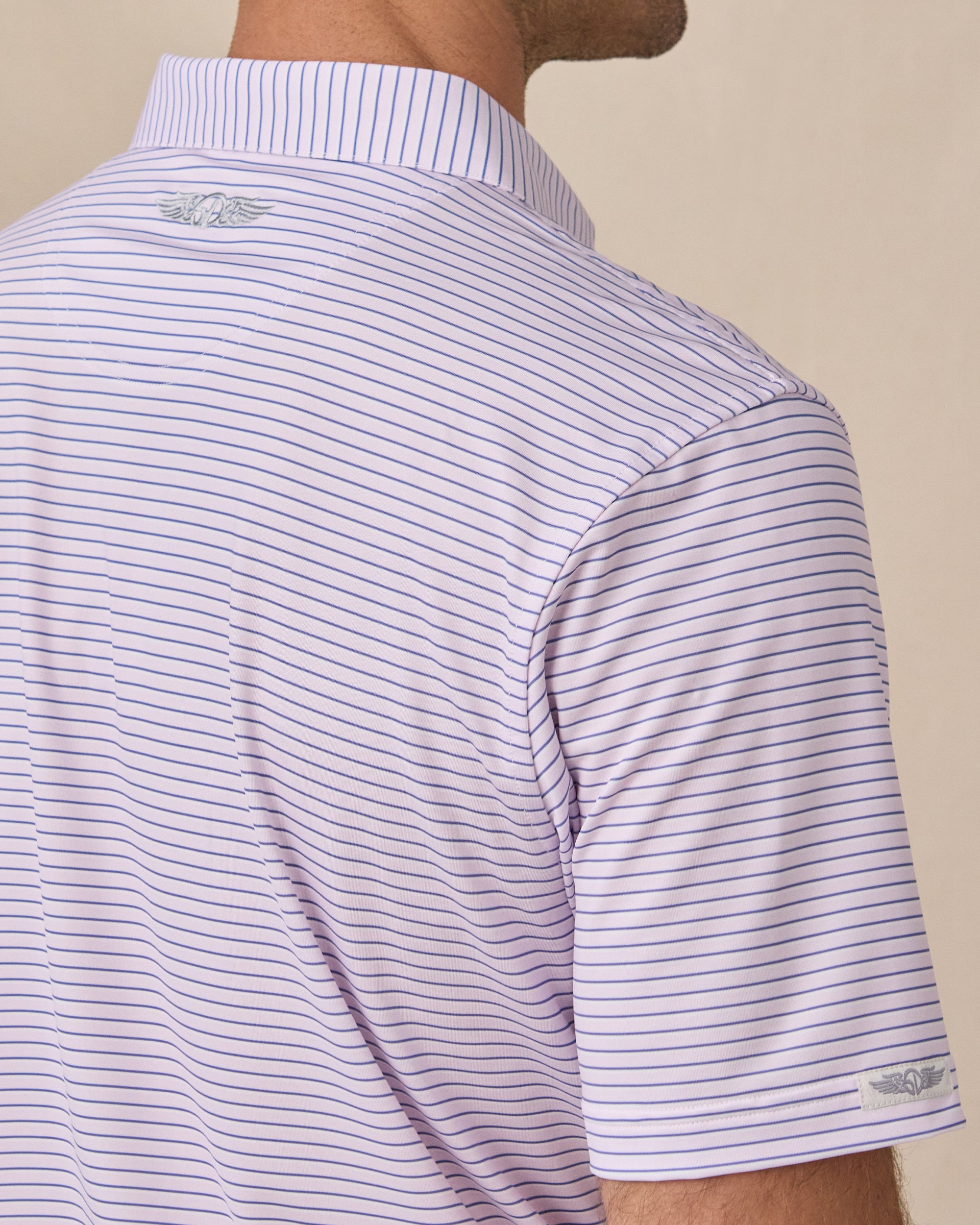 Close-up of the back shoulder on the Men's Channel Stripe Golf Polo in Lilac/Tidal, highlighting the embroidered Straight Down logo.